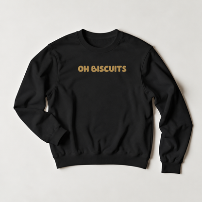 A black crewneck sweatshirt with the words 'OH BISCUITS' printed in a gold-colored retro font across the chest, displayed flat against a light gray background.