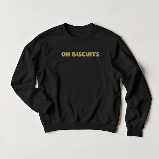 A black crewneck sweatshirt with the words 'OH BISCUITS' printed in a gold-colored retro font across the chest, displayed flat against a light gray background.